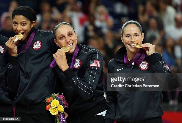 Candace Parker, Diana Taurasi and Sue Bird of United States bite their Gold Medals after the Women's Basketball Gold Medal game on Day 15 of the...