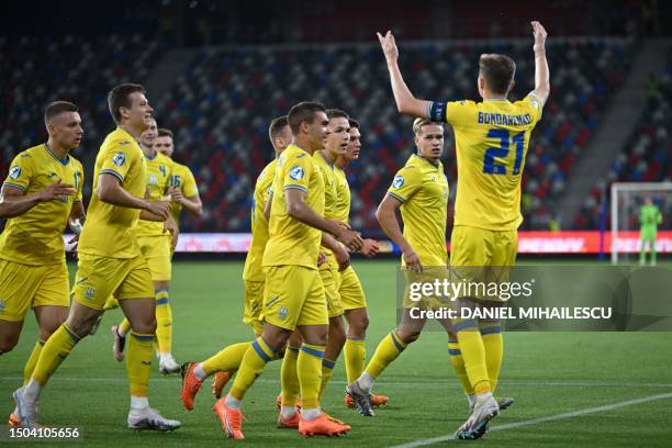 Ukraine's midfielder Artem Bondarenko celebrates scoring the opening goal with his teammates during the UEFA European Under-21 Championship...