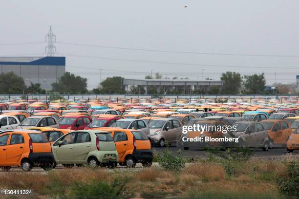 Tata Motors Ltd.'s Nano vehicles are parked at the company's factory in Sanand, Gujarat, India, on Wednesday, Aug. 8, 2012. India’s growth slowed to...