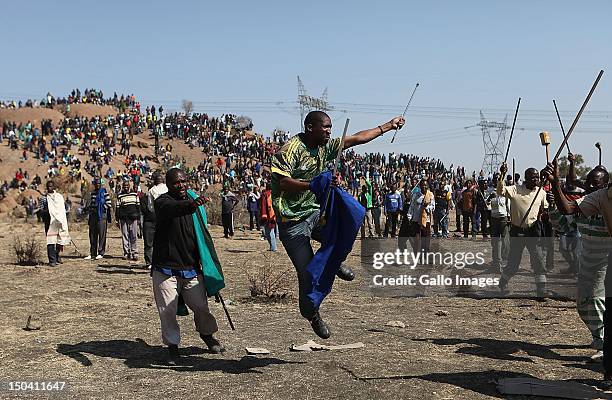 Striking mine workers demonstrate as they protest over wage demands outside the Nkageng informal settlement on August 16, 2012 in North West, South...