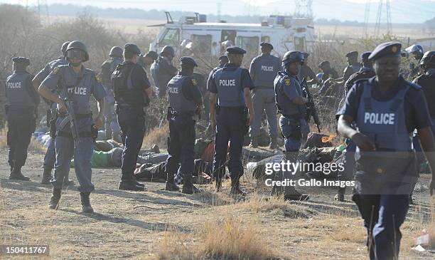 Police officers open fire on striking mine workers outside the Nkageng informal settlement on August 16, 2012 in Marikana, South Africa. 30 people...