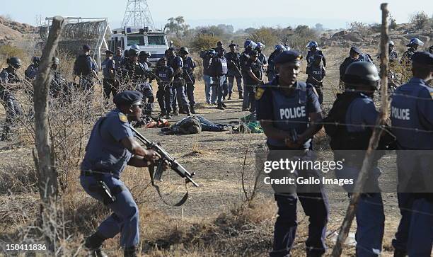 Police officers open fire on striking mine workers outside the Nkageng informal settlement on August 16, 2012 in Marikana, South Africa. 30 people...
