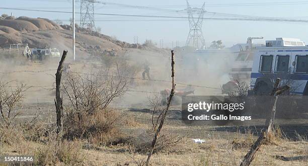 Police officers open fire on striking mine workers outside the Nkageng informal settlement on August 16, 2012 in Marikana, South Africa. 30 people...