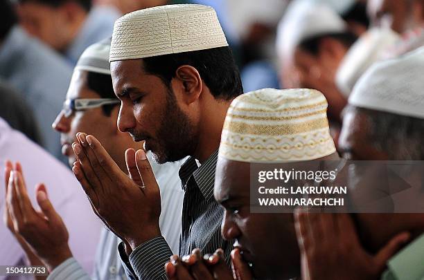 Sri Lankan Muslims take part in communal Friday noon prayers on the last Friday of the Muslim holy month of Ramadan in Colombo on August 17 ahead of...