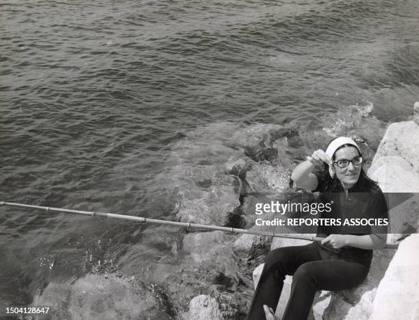 La chanteuse grecque Nana Mouskouri pêche pendant ses vacances au Cap d'Antibes en juillet 1967