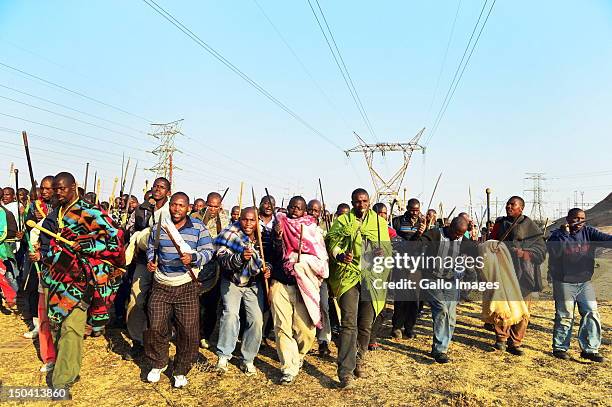 Thousands of striking mine workers demonstrate near Lonmin's Karee Platinum Mine demanding a wage increase on August 16, 2012 in Rustenburg, South...