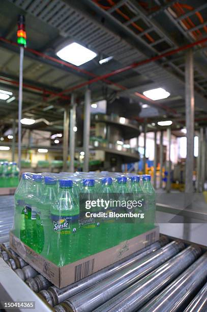 Packaged trays of Sprite move along a conveyor belt at Coca-Cola Amatil Ltd.'s production facility in the suburb of Moorabbin in Melbourne,...