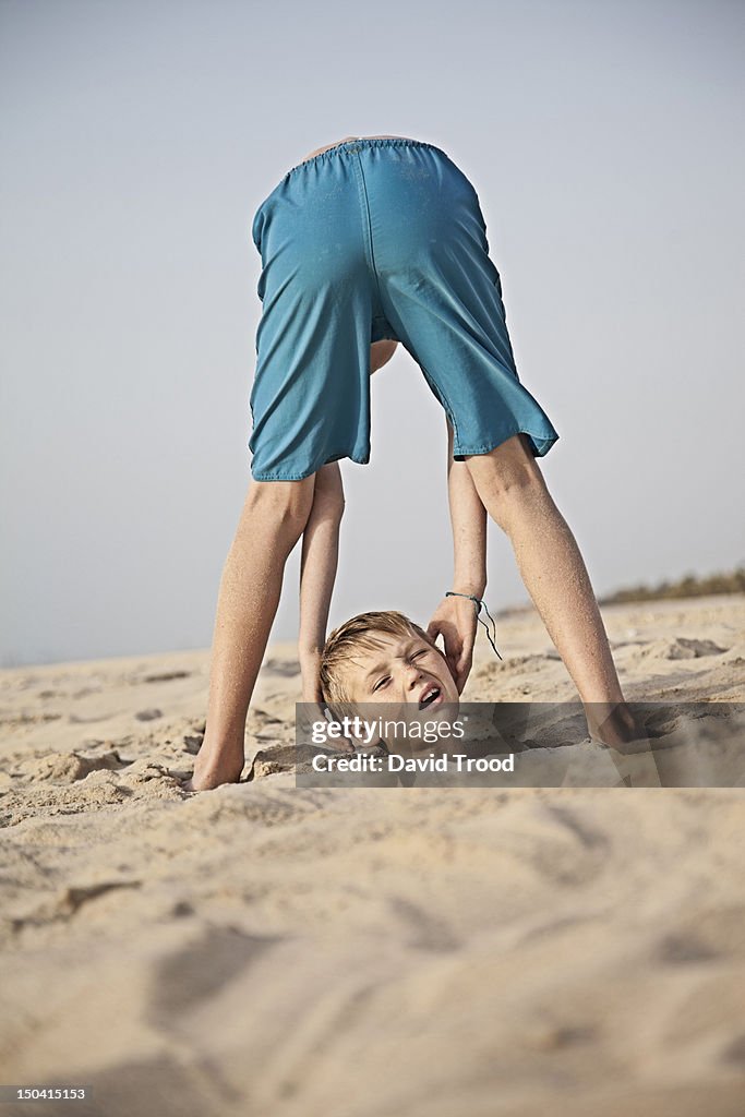 Boy drops his head on the beach in Dubai
