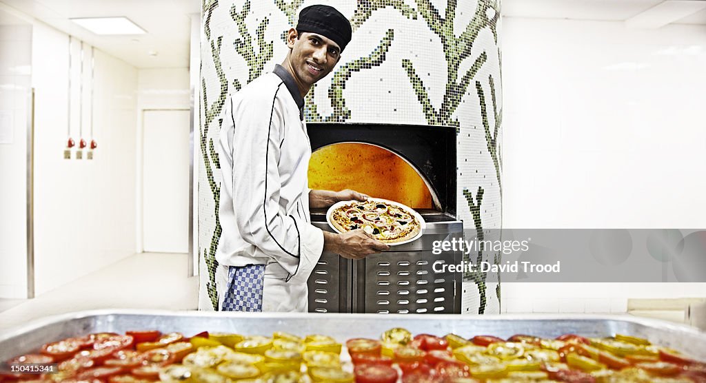 Chef working in industrial kitchen.