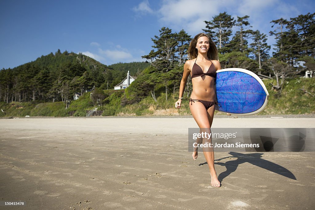 A woman heading out surfing.