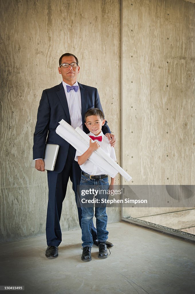 Architect at work on site with his son