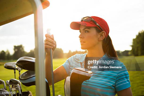 a female playing a round of golf. - women golf stock pictures, royalty-free photos & images