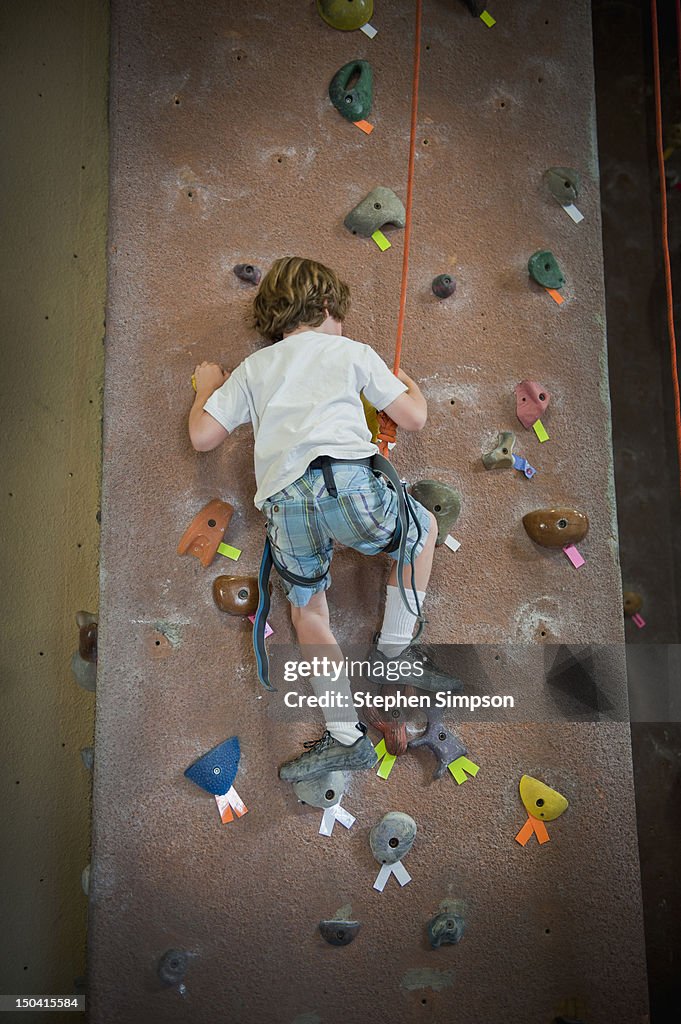 Boy, 7, on indoor rock-climbing wall