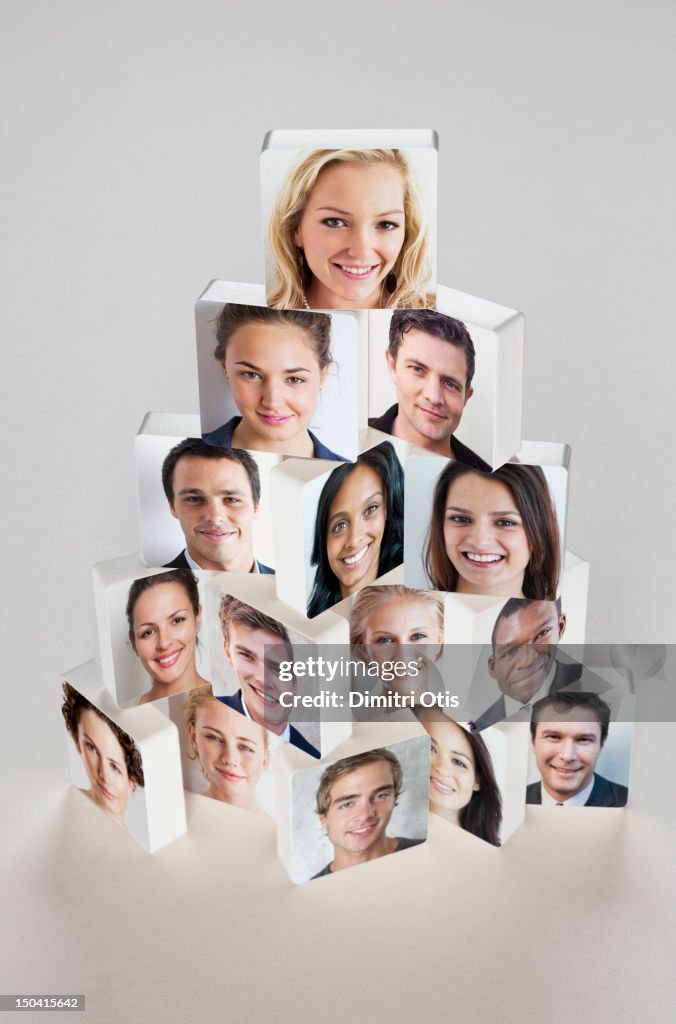 Disc's with faces in pyramid pile, woman at head