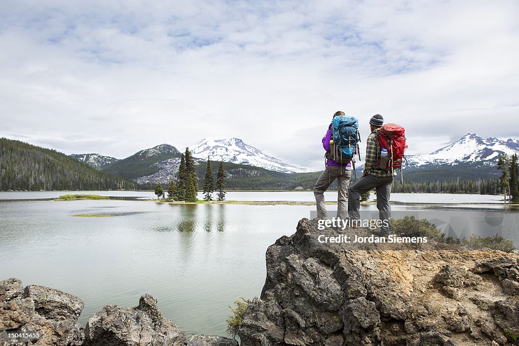 Backpackers standing on a scenic lookout.