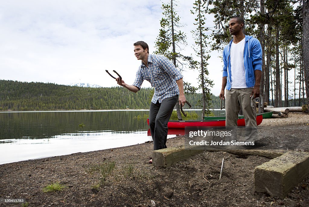 Men playing horseshoes.