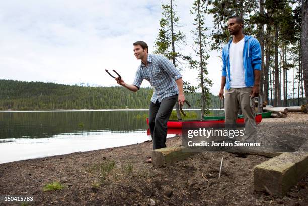 men playing horseshoes. - horseshoe stock pictures, royalty-free photos & images