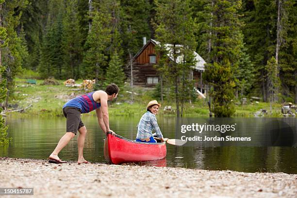 two people canoeing on a lake. - american lake stockfoto's en -beelden