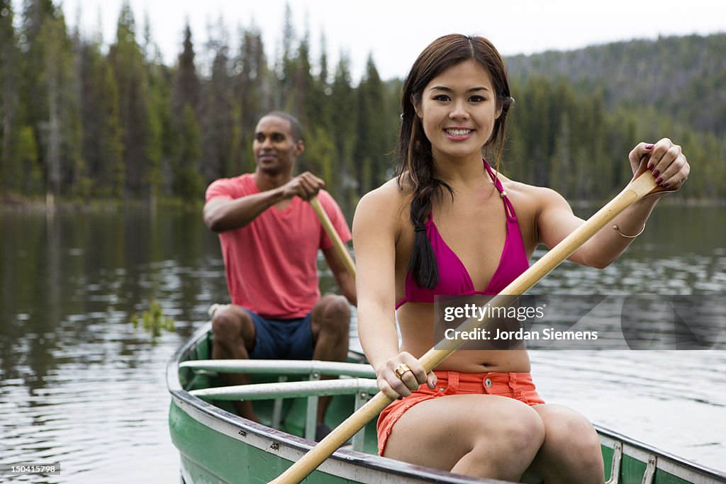 Two people canoeing on a lake.