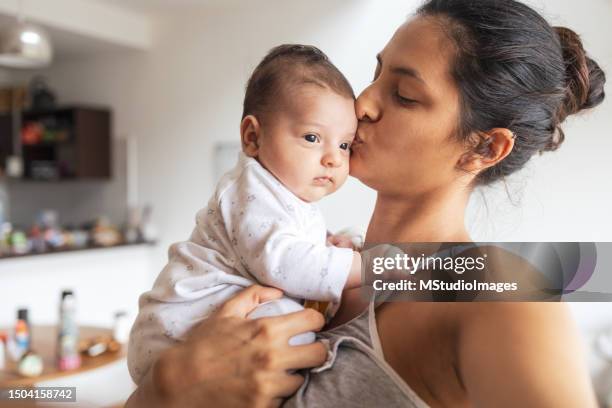 mother and baby at home - baby clothes stock pictures, royalty-free photos & images