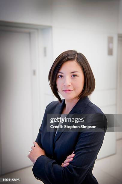 portrait, businesswoman in building lobby - woman short brown hair stock pictures, royalty-free photos & images