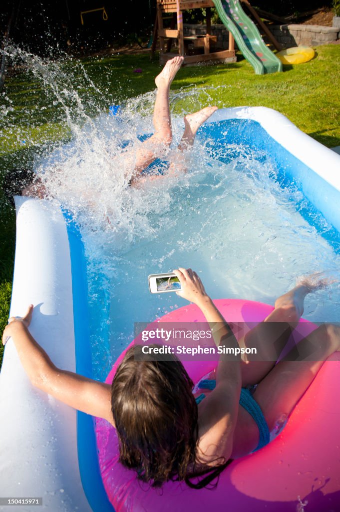 Making cell phone video of backyard pool crash