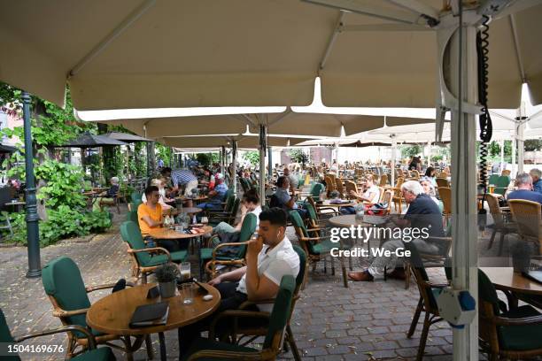 sidewalk cafes on the minster square in the old town of roermond. - limburg stockfoto's en -beelden