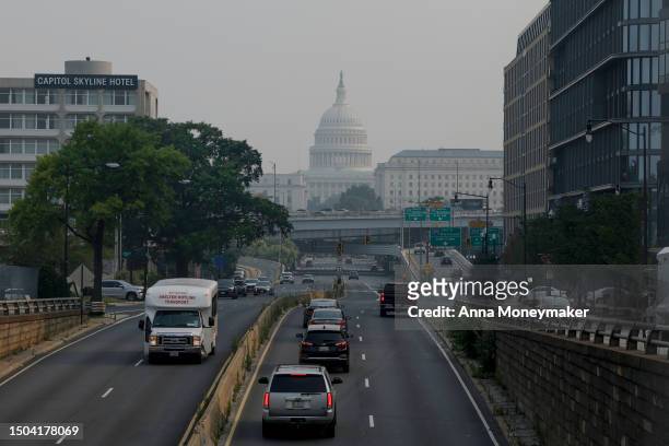 Cars drive in hazy smoke on South Capitol Street towards the U.S. Capitol Building on June 29, 2023 in Washington, DC. The Washington, DC region is...