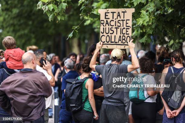 Protester holds a placard reading "Racist state, Quisling justice" as people gather to protest against racism and police violence in Toulouse,...