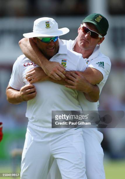 Graeme Smith of South Africa congratulates Jacques Kallis of South Africa after he caught out Alastair Cook of England for 7 runs off the bowling of...