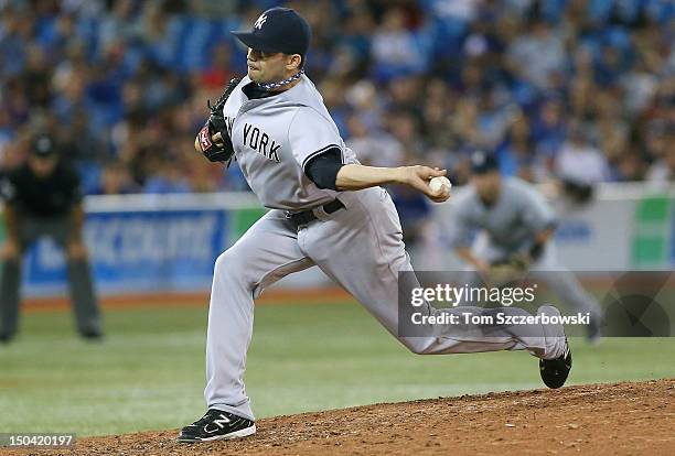 Clay Rapada of the New York Yankees delivers a pitch during MLB game action against the Toronto Blue Jays on August 10, 2012 at Rogers Centre in...