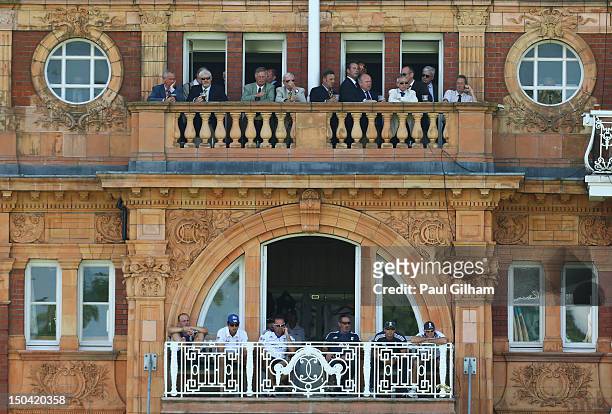 England Captain Andrew Strauss, coach Andy Flower, Jonathan Trott, and Alastair Cook look on from the team balcony as Ian Bell and Jonny Bairstow of...