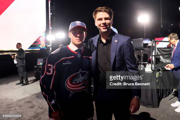 Gavin Brindley poses with Adam Fantilli after being selected 34th overall pick by the Columbus Blue Jackets during the 2023 Upper Deck NHL Draft at...