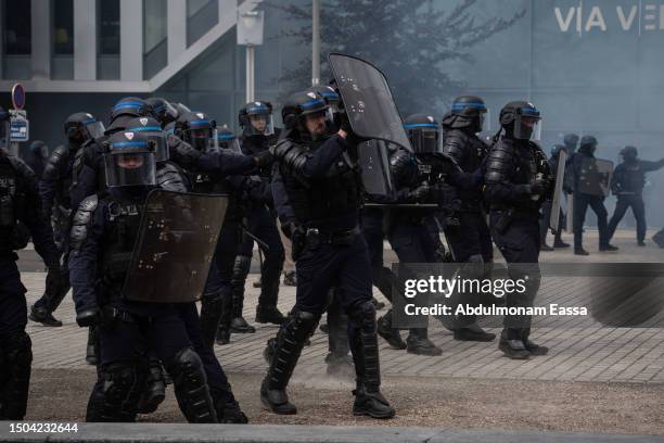 French riot police face protestors after a memorial march for French teenager Nahel, shot by police during a traffic control stop several days ago,...