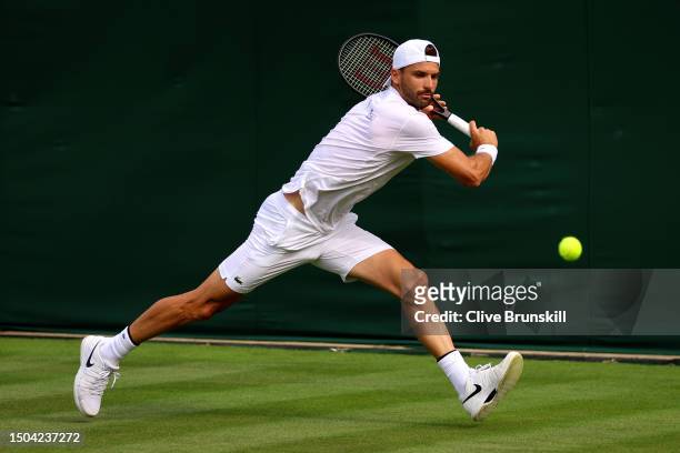 Grigor Dimitrov of Bulgaria plays a backhand during a practice session ahead of The Championships - Wimbledon 2023 at All England Lawn Tennis and...