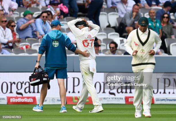 Nathan Lyon of Australia leaves the field injured during Day Two of the LV= Insurance Ashes 2nd Test match between England and Australia at Lord's...