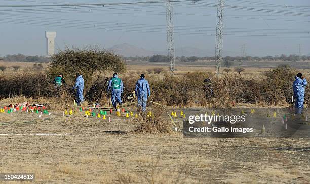 Forensic experts investigate the scene of the shooting that took place outside the Nkaneng informal settlement near Lonmin Mine on August 17, 2012 in...