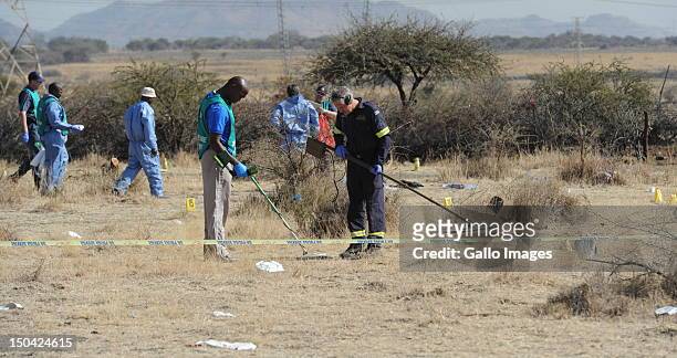 Forensic experts investigate the scene of the shooting that took place outside the Nkaneng informal settlement near Lonmin Mine on August 17, 2012 in...
