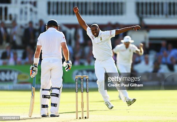 Vernon Philander of South Africa celebrates taking the wicket of Ian Bell of England for 58 runs after he was caught out by Alviro Petersen of South...