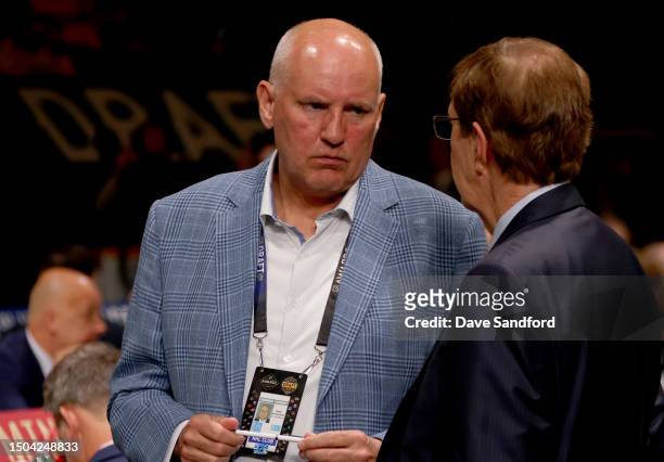 Doug Armstrong of the St. Louis Blues and David Poile talk on the draft floor during the 2023 Upper Deck NHL Draft - Rounds 2-7 at Bridgestone Arena...
