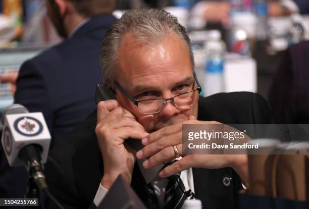 Kevin Cheveldayoff of the Winnipeg Jets talks on his phone during the 2023 Upper Deck NHL Draft - Rounds 2-7 at Bridgestone Arena on June 29, 2023 in...
