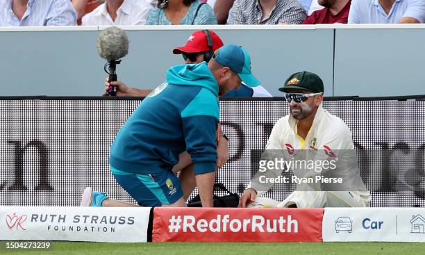 Nathan Lyon of Australia leaves the field injured during Day Two of the LV= Insurance Ashes 2nd Test match between England and Australia at Lord's...