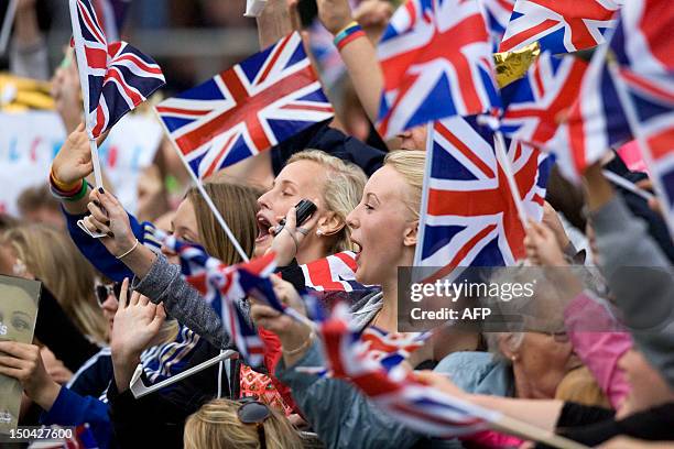 The crowd cheers as British athlete Jessica Ennis holds her Olympic gold medal as she arrives for a homecoming party at the Sheffield Town Hall in...