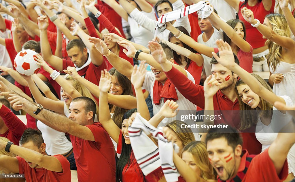 Group of football fans cheering.