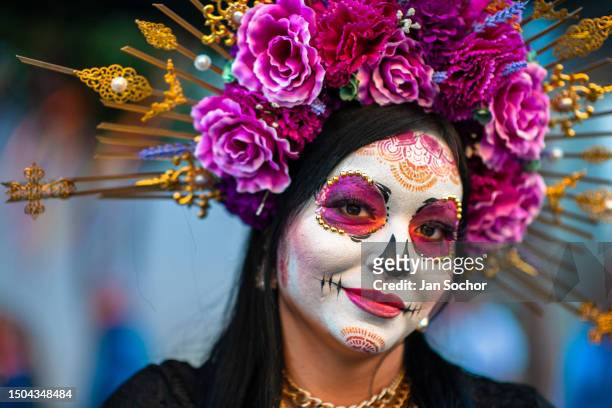 Young Mexican woman, dressed as La Catrina, a Mexican pop culture character representing the Death, takes part in the Day of the Dead festivities on...