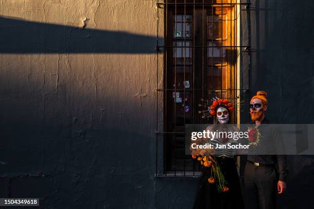 Young Mexican woman, dressed as La Catrina, and a young Mexican man, dressed as Catrín, take part in the Day of the Dead festivities on October 29,...