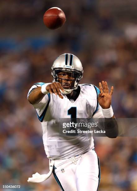 Cam Newton of the Carolina Panthers throws a pass against the Miami Dolphins during their preseason game at Bank of America Stadium on August 17,...