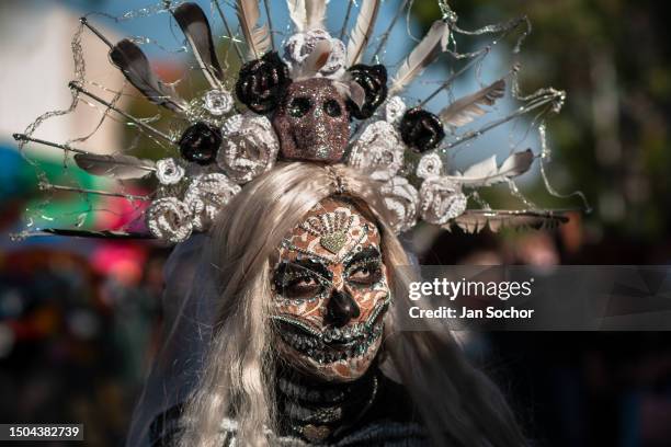 Young Mexican woman, dressed as La Catrina, a Mexican pop culture character representing the Death, takes part in the Day of the Dead festivities on...