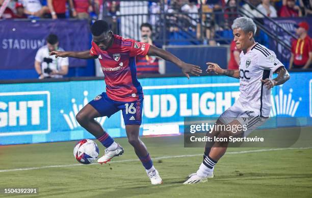 Dallas midfielder Katlego Ntsabeleng tries to keep the ball away from D.C. United defender Andy Najar during the second half of a MLS soccer game...