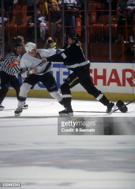 Matt Johnson of the Los Angeles Kings fights with Derian Hatcher of the Dallas Stars on November 15, 1997 at the Great Western Forum in Inglewood,...